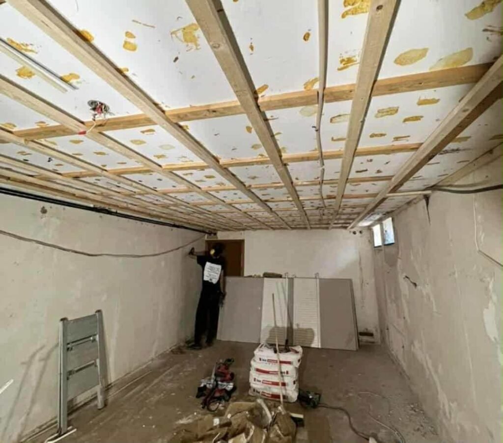 Under-construction basement with exposed ceiling electric service